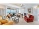 Bright living room with stylish furniture, a ceiling fan, and sliding doors that open to a balcony with an ocean view at 7554 Palm Island S Dr # 1822, Placida, FL 33946