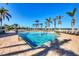 Community pool featuring lounge seating, crystal blue water, with palm trees, perfect for relaxation at 8411 Placida Rd # 308, Placida, FL 33946