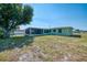 Expansive backyard featuring a screened lanai and lush greenery, creating an inviting outdoor space for relaxation at 842 E 6Th St, Englewood, FL 34223
