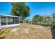 Spacious backyard with a screened lanai, complemented by a boat dock and serene canal view at 842 E 6Th St, Englewood, FL 34223
