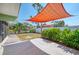 Well-maintained backyard featuring a patio, lush landscaping, and a partial fence for privacy at 842 E 6Th St, Englewood, FL 34223