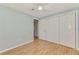Bedroom featuring wood floors and a ceiling fan next to a closet with double doors at 842 E 6Th St, Englewood, FL 34223