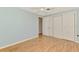 Charming bedroom with wood floor and a closet with double doors for optimal storage space at 842 E 6Th St, Englewood, FL 34223