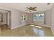 Bedroom with wood-look floors, lighted ceiling fan, and windows with light-filtering curtains at 842 E 6Th St, Englewood, FL 34223