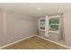 Small bedroom featuring wood-look floors, neutral paint, and a large window at 842 E 6Th St, Englewood, FL 34223