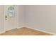 Bright entryway with wood floors, glass door with decorative details, and neutral paint at 842 E 6Th St, Englewood, FL 34223