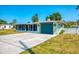 Charming home featuring a large driveway, nautical-themed accents, and a screened-in lanai for outdoor living at 842 E 6Th St, Englewood, FL 34223