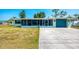 Charming house features a large driveway, nautical-themed accents, and a screened-in lanai for outdoor living at 842 E 6Th St, Englewood, FL 34223