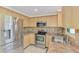 Updated kitchen with stainless steel appliances and tile backsplash at 842 E 6Th St, Englewood, FL 34223