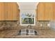 Kitchen sink with view through window to exterior of property at 842 E 6Th St, Englewood, FL 34223