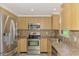 Kitchen with updated stainless steel appliances and light wood cabinets at 842 E 6Th St, Englewood, FL 34223