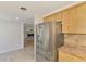 Modern kitchen features stainless steel fridge and open view to living area at 842 E 6Th St, Englewood, FL 34223