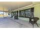 Enjoy relaxing on this covered lanai with comfortable seating and views of the property's attractive landscaping at 842 E 6Th St, Englewood, FL 34223