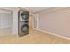 Laundry room featuring wood-look floors, neutral paint, and a stacked washer and dryer set at 842 E 6Th St, Englewood, FL 34223