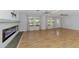 Open living room with wood floors, a fireplace and abundant natural light at 842 E 6Th St, Englewood, FL 34223