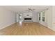 Bright living room with wood floors, ceiling fan, and a modern electric fireplace at 842 E 6Th St, Englewood, FL 34223
