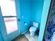 Bright blue bathroom with door to the exterior at 8472 Grand Ave, Placida, FL 33946