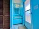 Bathroom has cabinet sink, bright blue paint, and tiled floors at 8472 Grand Ave, Placida, FL 33946