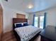 Bedroom featuring a woven-style bed frame and a dark dresser at 8472 Grand Ave, Placida, FL 33946