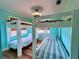 Charming bunk room with two bunk beds, wood floors, and windows with bamboo blinds at 8472 Grand Ave, Placida, FL 33946