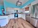Farmhouse style kitchen with stainless steel appliances and hardwood flooring at 8472 Grand Ave, Placida, FL 33946