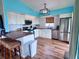 Charming kitchen features white cabinetry, stainless steel appliances, butcher block countertops, and lovely backsplash at 8472 Grand Ave, Placida, FL 33946