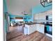 Open-concept living room, kitchen, and dining area with hardwood flooring at 8472 Grand Ave, Placida, FL 33946