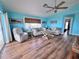 Bright living room featuring hardwood floors, a ceiling fan, and comfortable seating at 8472 Grand Ave, Placida, FL 33946