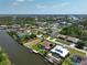 Community aerial view showing residences along the waterfront with canals, boat docks, and lush landscaping at 9158 Melody Cir, Port Charlotte, FL 33981
