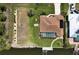 Aerial view showcasing a private pool, well-maintained yard, and waterfront access with a dock at 9158 Melody Cir, Port Charlotte, FL 33981