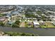 Community aerial view of tranquil waterfront living with boat docks, canals and a lush tree canopy at 9158 Melody Cir, Port Charlotte, FL 33981