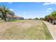 Spacious backyard showing ample space with grass and palm trees at 9158 Melody Cir, Port Charlotte, FL 33981