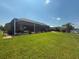 Expansive backyard featuring lush green grass and a screened-in patio area perfect for outdoor living at 9158 Melody Cir, Port Charlotte, FL 33981