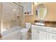 Bathroom featuring tiled shower, a vanity with counter space, and ample lighting at 9158 Melody Cir, Port Charlotte, FL 33981