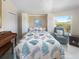 The beautiful guest bedroom features a comfortable bed and a cozy sitting area at 9158 Melody Cir, Port Charlotte, FL 33981