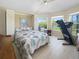 This cozy bedroom features a leafy-print bedspread and a view of the waterway at 9158 Melody Cir, Port Charlotte, FL 33981