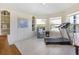 Exercise room with a treadmill, seating area, and scenic view from large windows at 9158 Melody Cir, Port Charlotte, FL 33981