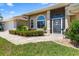 Home exterior boasts lush landscaping, beautiful windows, and a decorative security door at 9158 Melody Cir, Port Charlotte, FL 33981
