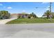 Charming single-story home with a well-maintained lawn and mature palm trees, offering great curb appeal at 9158 Melody Cir, Port Charlotte, FL 33981
