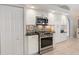 Updated kitchen with stainless steel appliances, white cabinets, and modern backsplash at 9158 Melody Cir, Port Charlotte, FL 33981