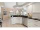 Bright kitchen with granite counters, stainless appliances, white cabinets, and view of dining area at 9158 Melody Cir, Port Charlotte, FL 33981
