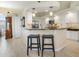 Well-lit kitchen showcasing an island with seating and modern appliances plus clean white cabinetry at 9158 Melody Cir, Port Charlotte, FL 33981