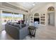 Open living room featuring neutral decor, built-in shelving, and access to the screened-in patio at 9158 Melody Cir, Port Charlotte, FL 33981