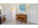 Music room featuring upright piano, adjacent doors and closet, and light, tiled floors at 9158 Melody Cir, Port Charlotte, FL 33981