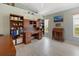 Home office with custom wooden desk, built-in shelving, and serene natural light at 9158 Melody Cir, Port Charlotte, FL 33981