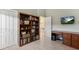Spacious office with storage, adjacent desk, and stylish built-in bookshelves at 9158 Melody Cir, Port Charlotte, FL 33981