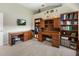 Bright office features two wooden desks, ample storage, and streamlined design at 9158 Melody Cir, Port Charlotte, FL 33981