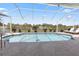 A pristine pool is enclosed in a screened cage, offering protection from bugs at 9158 Melody Cir, Port Charlotte, FL 33981