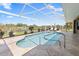 This pristine pool features a screened enclosure and lovely views of the canal at 9158 Melody Cir, Port Charlotte, FL 33981