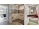 Elegant tiled shower featuring glass door, neutral color scheme, and built-in bench at 9158 Melody Cir, Port Charlotte, FL 33981